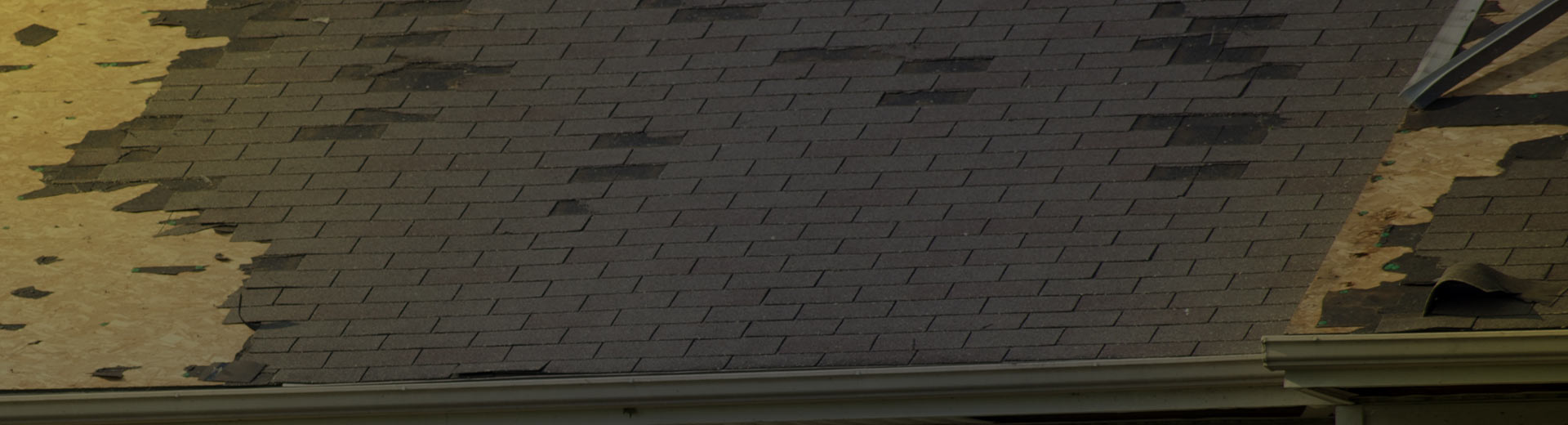 zoomed in photo of a shingle roof after storm damage lansing mi